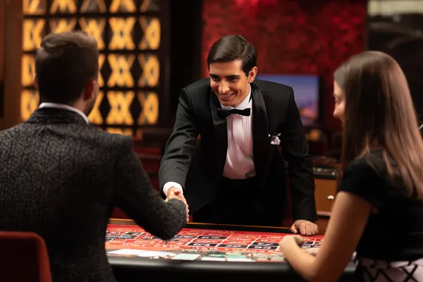 88FD — A high-class gaming experience without limits A woman in a luxurious green gown next to an ornate roulette wheel, capturing the upscale casino mood of 88FD.